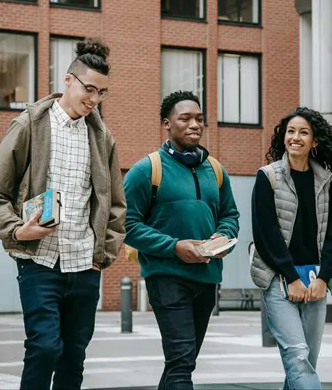 A group of older students laughing and studying together, representing Teneo's AS & A Level Full A Level pathway for international university preparation