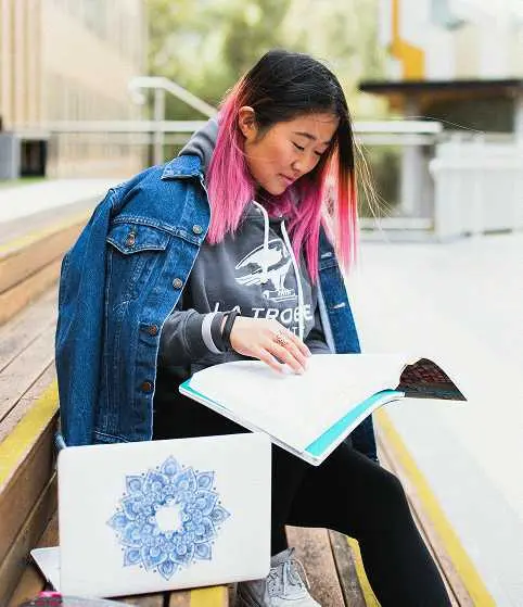 Two students studying together at a library, representing Teneo's International GCSE Pearson Edexcel qualification pathway