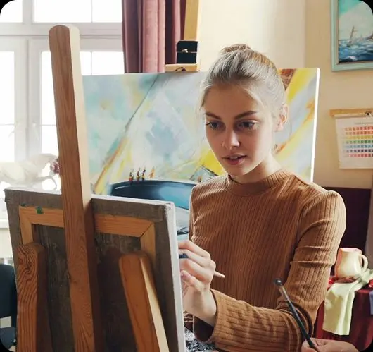 A student engaged in creative painting at an easel, representing neurodiverse learners supported by Teneo Online School's personalised approach