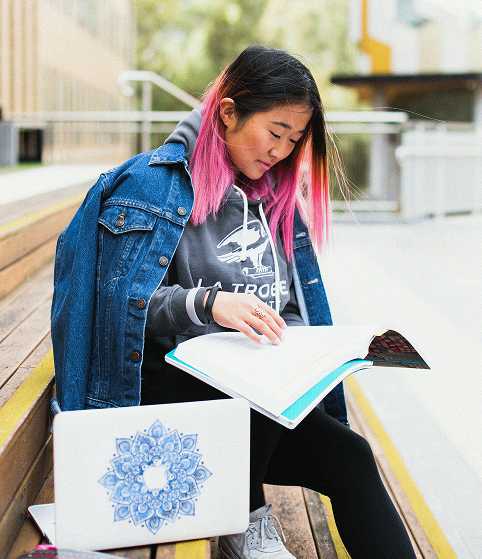 Two students studying together at a library, representing Teneo's International GCSE Pearson Edexcel qualification pathway
